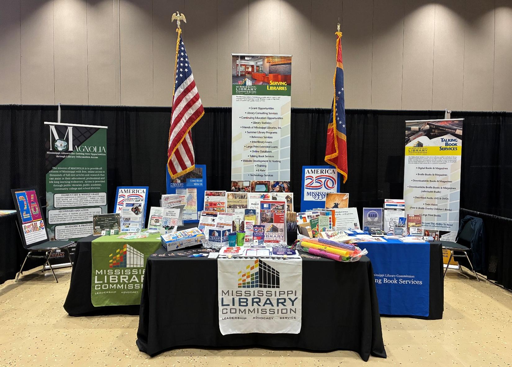 MLC Booth A 3 table booth for the Mississippi Library Commission, the MLC Talking Book Services, and for America 250.