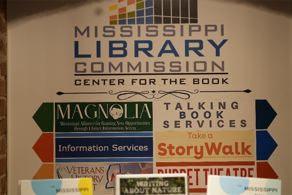 MLC-Center-for-the-Book Poster showing Mississippi Library Commission Center for the Book with sections labeled Magnolia, Talking Book Services, StoryWalk, and Puppet Theatre.